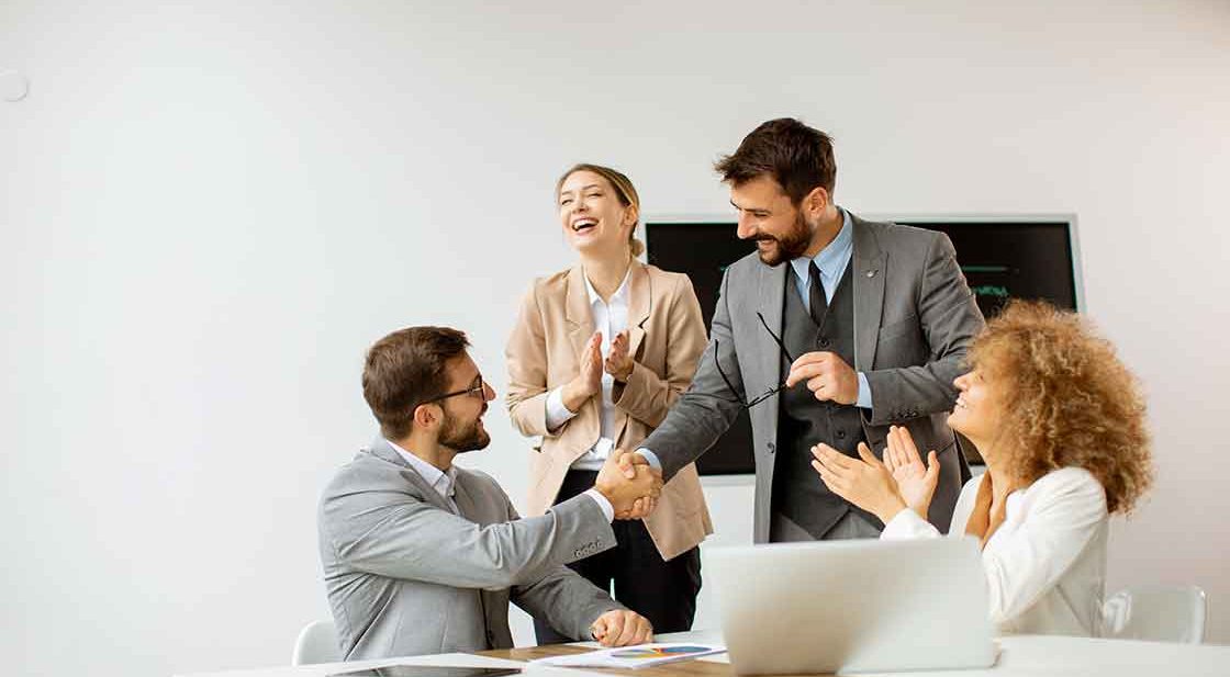 Business colleagues celebrate a deal.