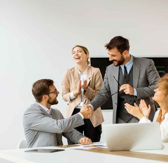 Business colleagues celebrate a deal.