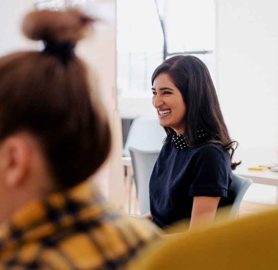 Smiling woman in office setting.