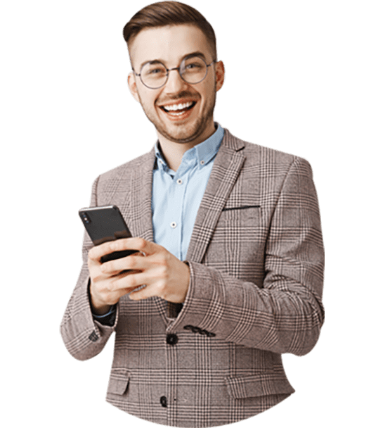 Smiling man in suit using phone.